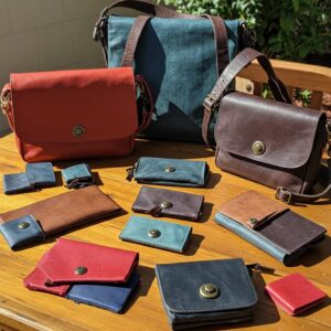 A collection of recycled and upcycled leather products including bags and wallets, emphasizing sustainability and craftsmanship