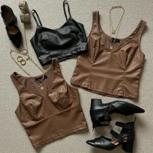 Stylish leather tops including a cropped top, tank, and blouse with accessories on a textured background